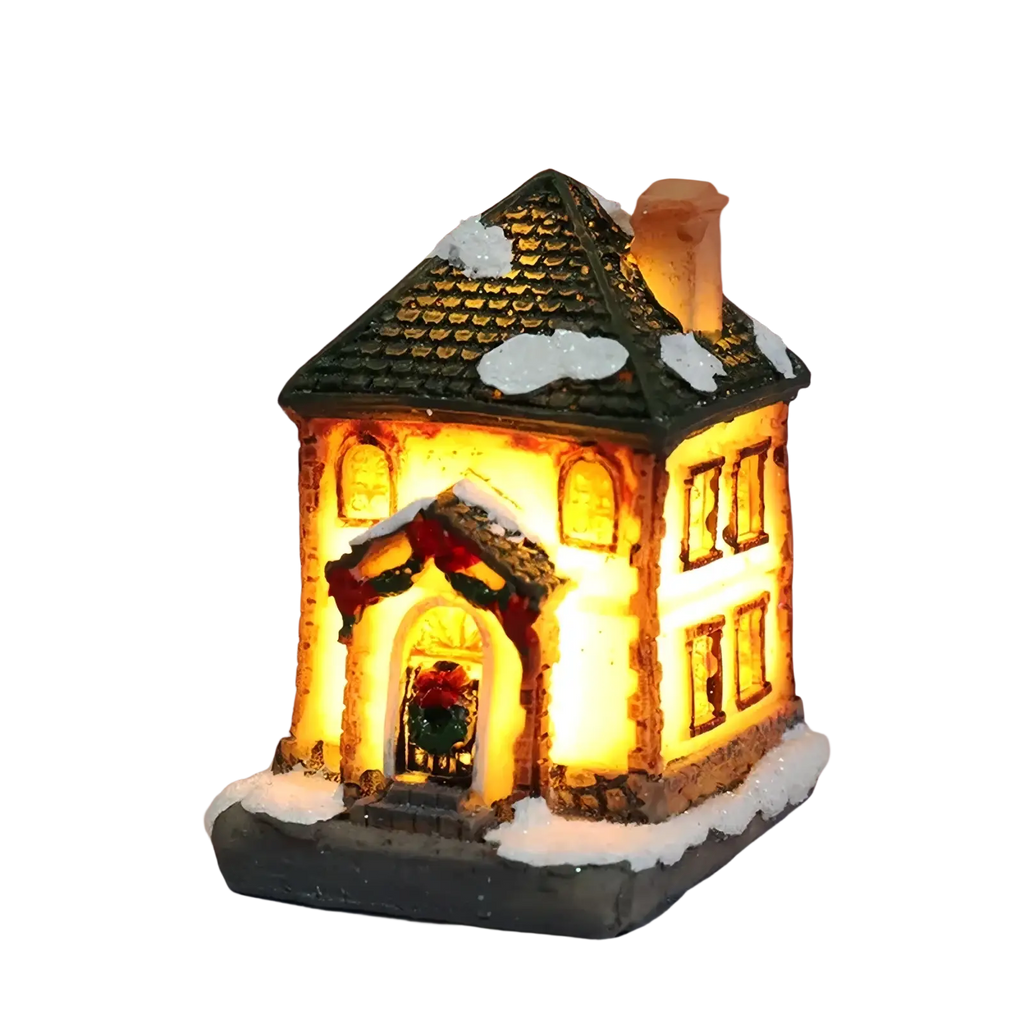A warmly lit led christmas village house with green tiled roof snow-dusted details and festive garlands at night