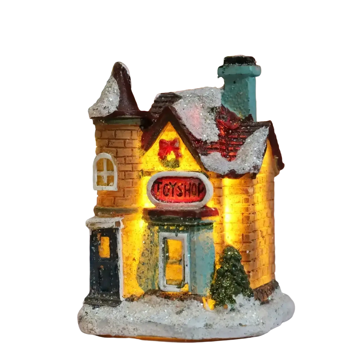A warmly lit led christmas village toy shop with yellow brick facade snow-dusted roof and festive holiday decorations