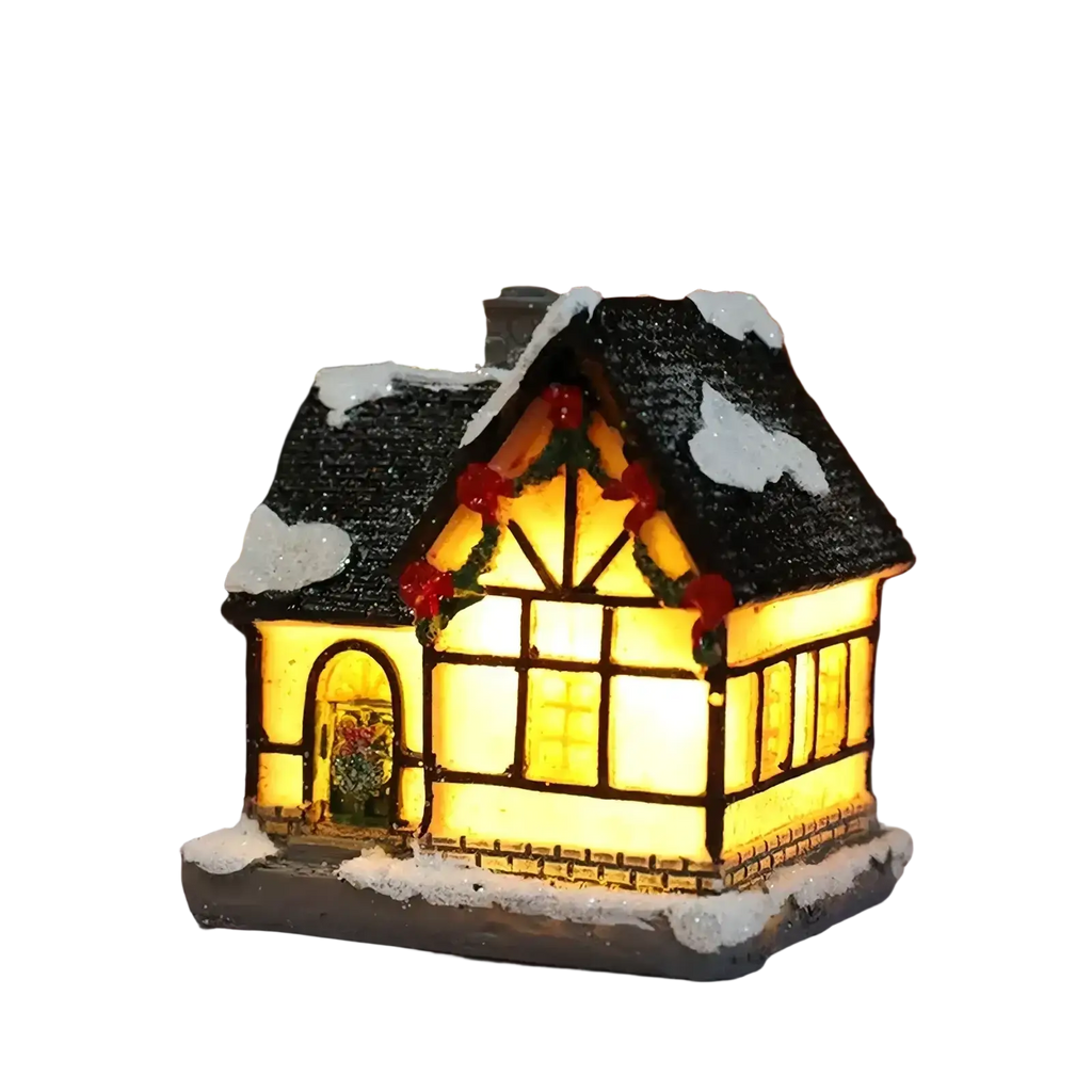 A warmly lit led christmas village miniature tudor-style house with black shingled roof and festive red berries