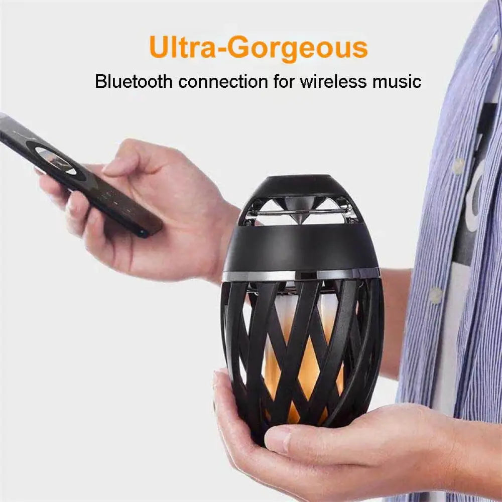 Arbaglobal led flame bluetooth speaker in black with lantern style woven mesh design and glowing orange interior light
