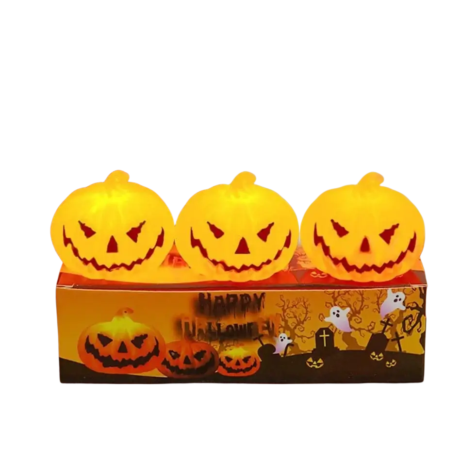 Three glowing orange led halloween pumpkin lights with carved faces sit atop a decorative box in a 6-pack