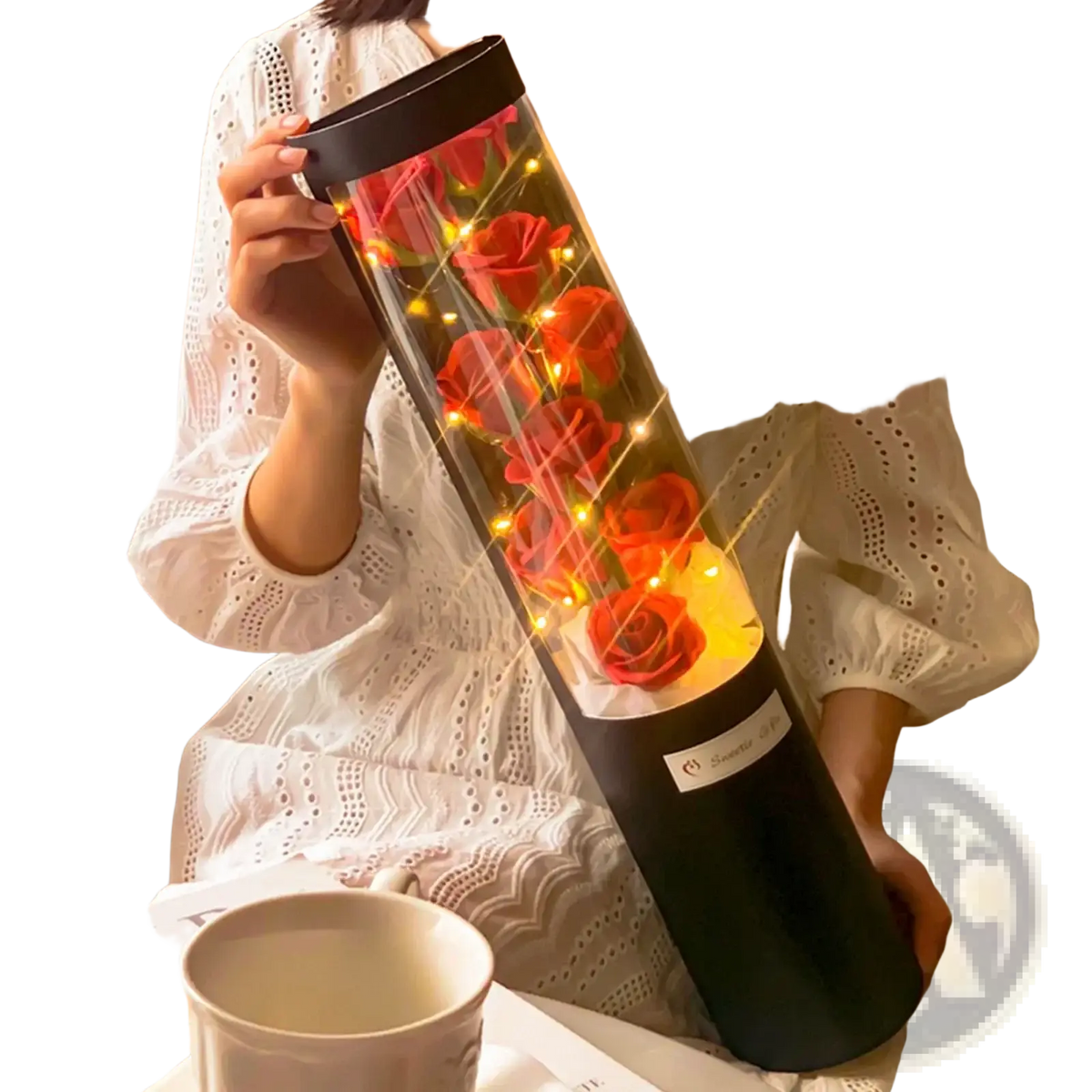 Led rose soap flower gift box with red roses in a cylindrical black and clear glass container illuminated by warm fairy lights