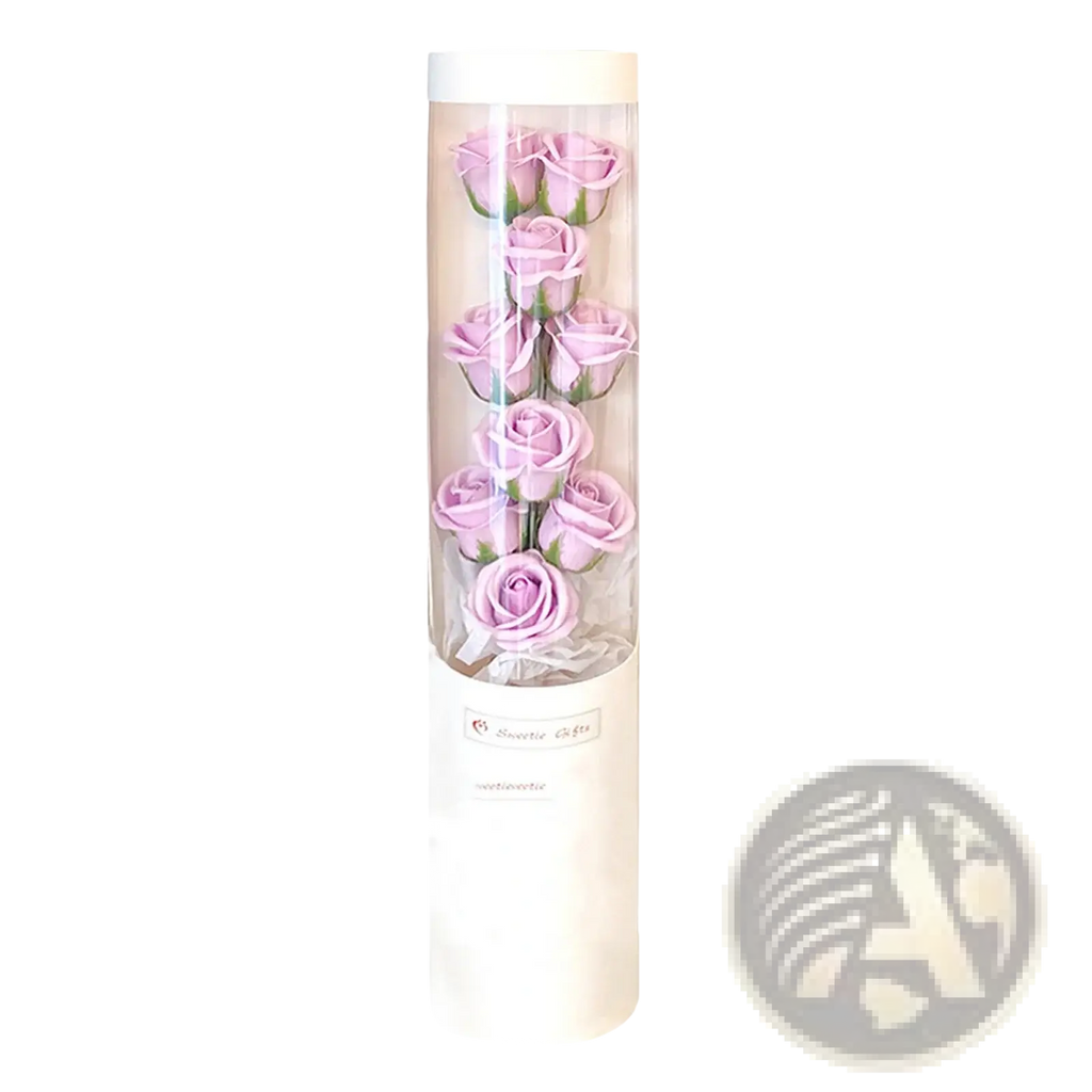 A clear cylindrical container holding six lavender soap roses with green stems in a led rose soap flower gift box for Valentine’s Day
