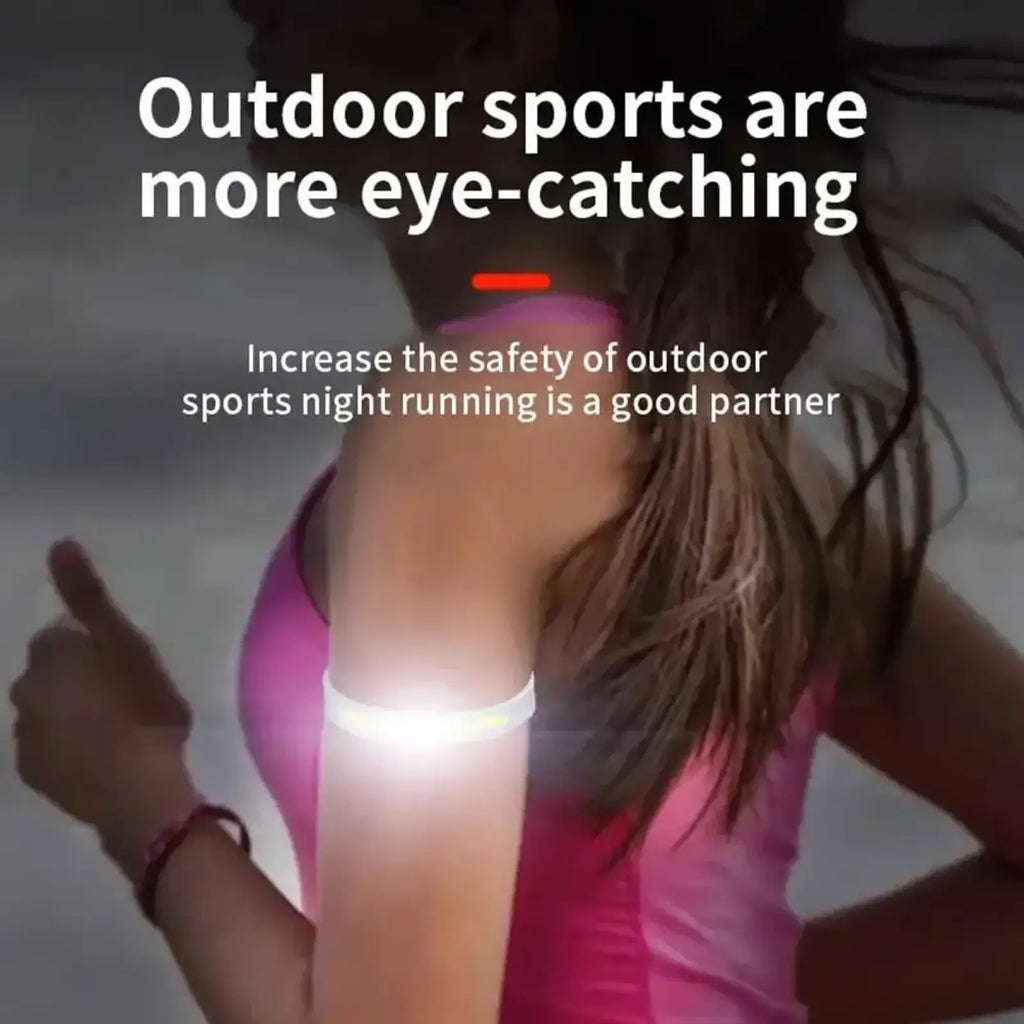A glowing white led running arm light rechargeable safety band worn on a runner’s arm for visibility and safety