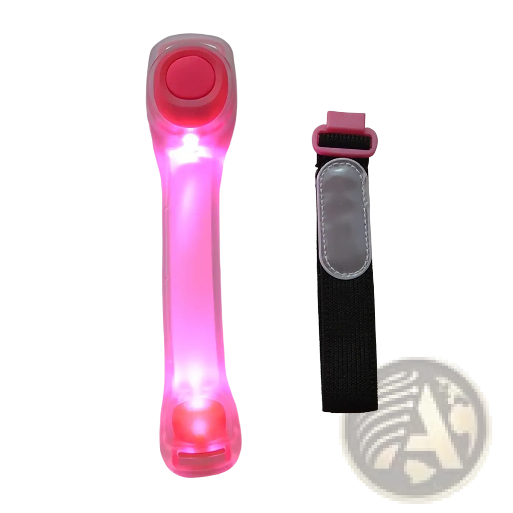 Led running armband with pink rechargeable safety light clear plastic body red button and black adjustable strap with pink buckle