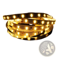 Coiled waterproof flexible led strip light with warm white illumination and black silicone backing for home decor