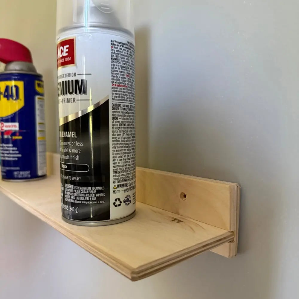 White metal 36 inch garage ledge shelf with black and white rust-oleum premium exterior enamel primer aerosol cans