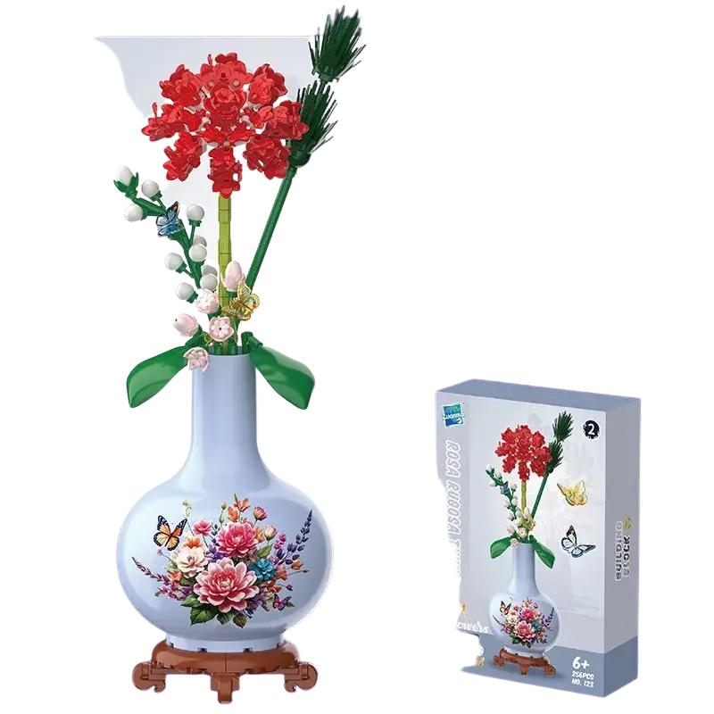 A white ceramic vase with floral butterfly design holding red carnation flowers made of Lego compatible blocks