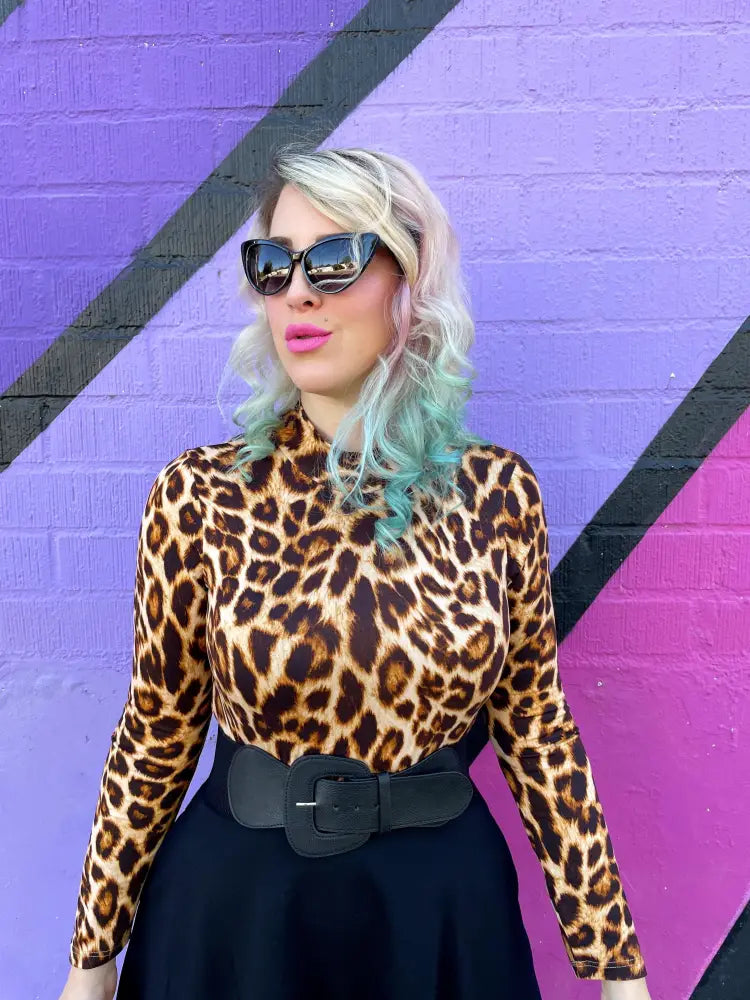 Vintage leopard print long sleeve top with mock neck and fitted silhouette in bold leopard pattern