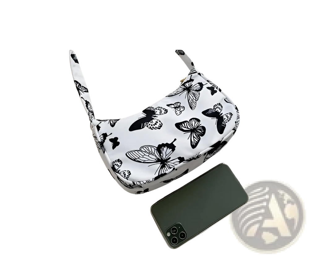 White canvas shoulder bag with black butterfly print complementing leopard print and checkered nylon underarm bag design