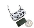 White canvas shoulder bag with black butterfly print complementing leopard print and checkered nylon underarm bag design