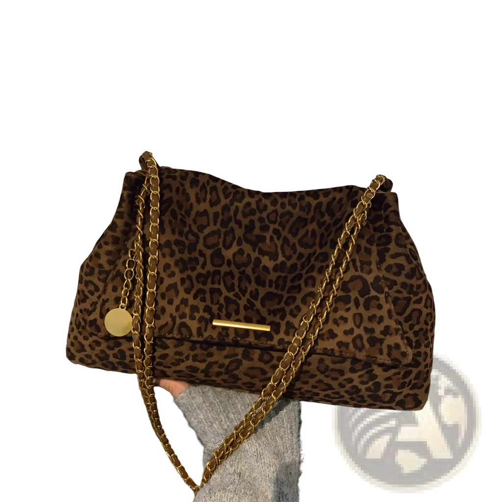 Brown leopard-print suede crossbody bag with gold chain strap and circular metal charm