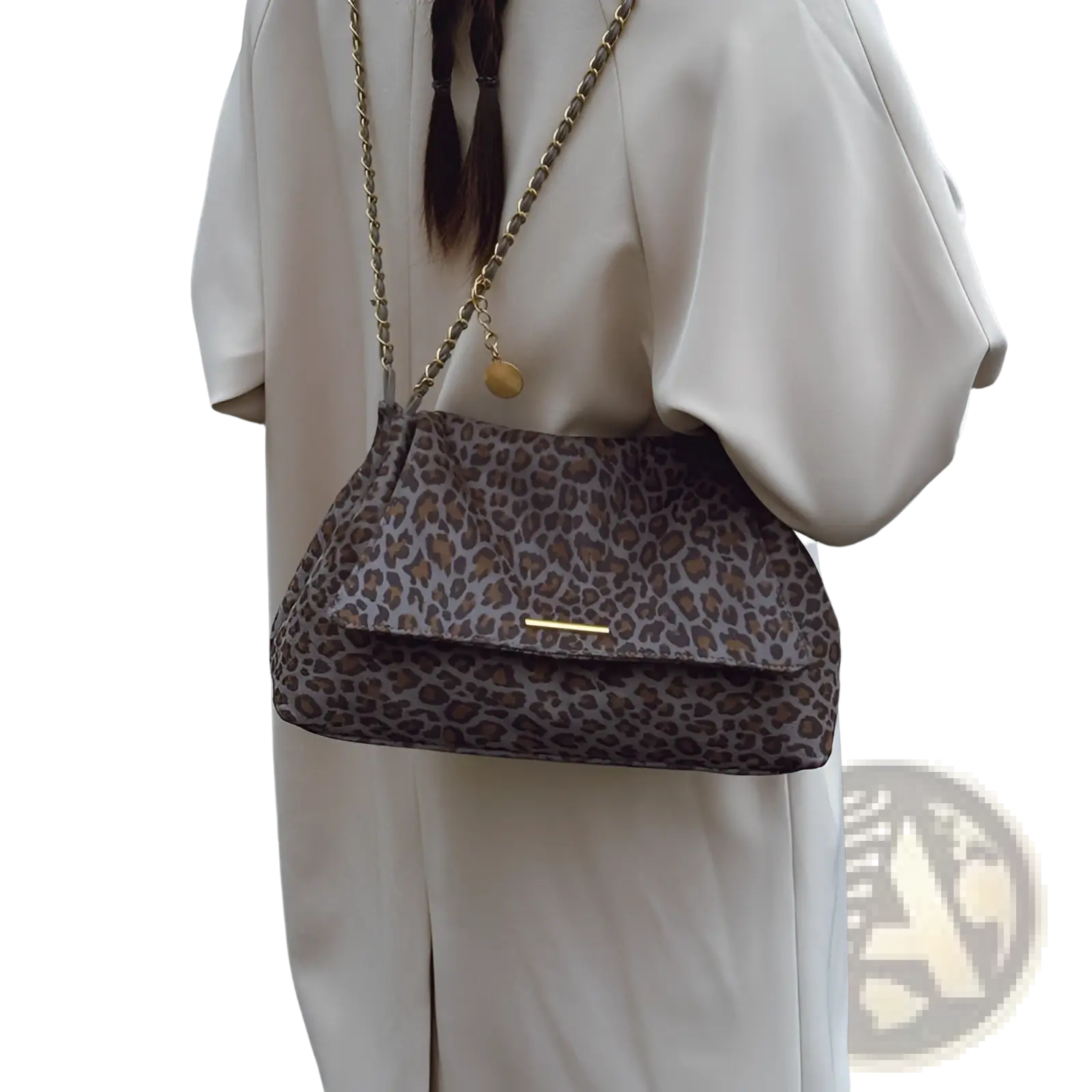 Leopard print crossbody bag with gold chain strap and small round charm in a stylish animal print design
