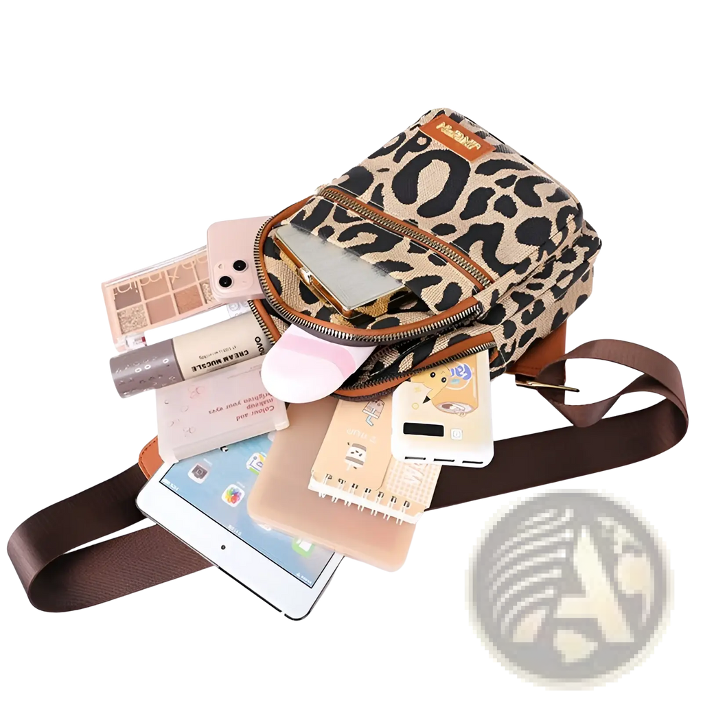 Leopard print canvas crossbody bag with brown leather trim and adjustable strap featuring headphone jack