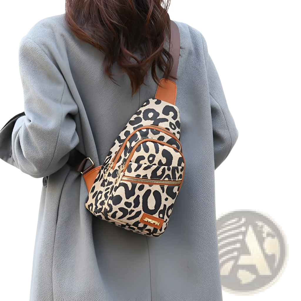 Leopard print canvas crossbody bag with tan leather trim and zipper accents featuring a headphone jack