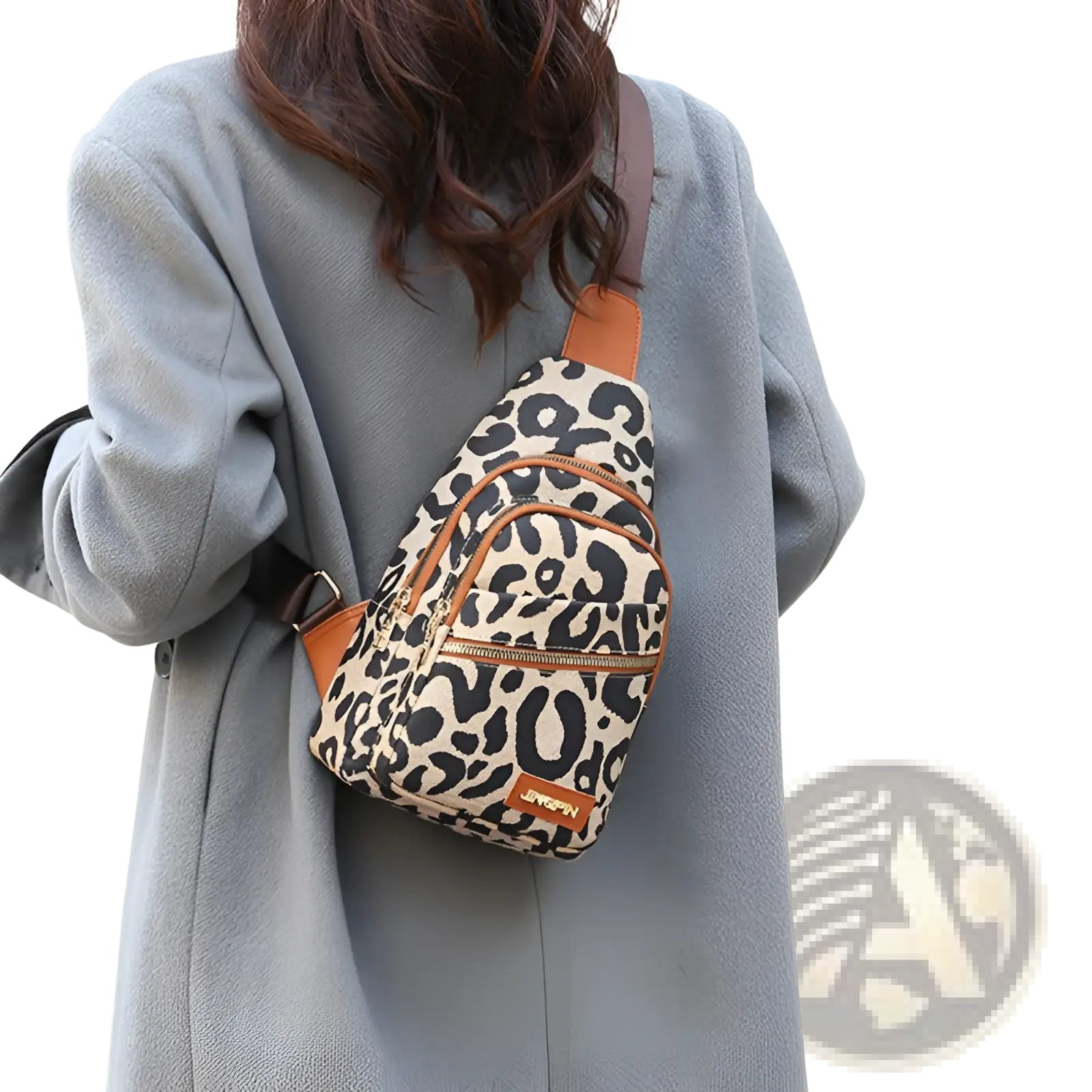 Leopard print canvas crossbody bag with tan leather trim and zipper accents featuring a headphone jack