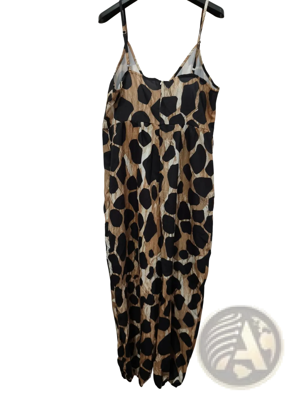 A flowing leopard print maxi dress with thin spaghetti straps and gathered waist made from lightweight fabric