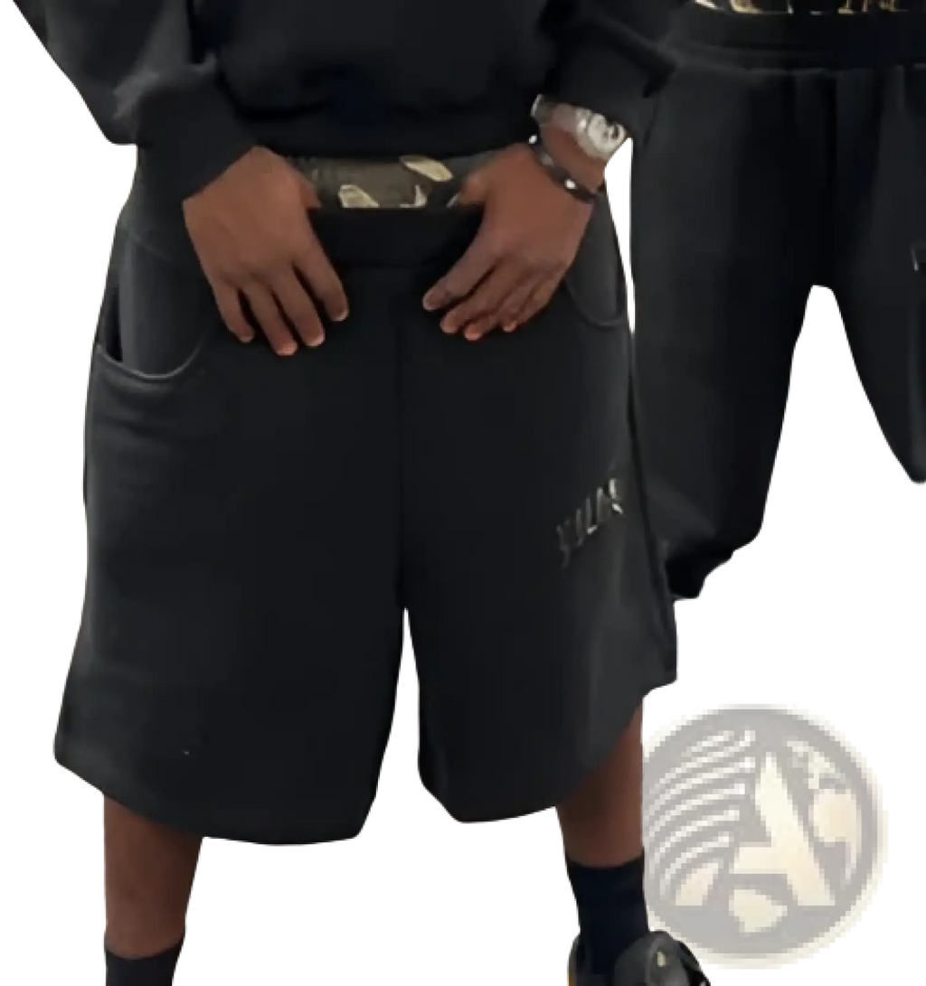 Black athletic shorts with subtle logo and camouflage belt paired with leopard print hoodie and sweatpants set