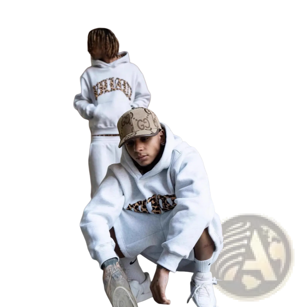 White hoodie with leopard print lettering paired with a matching gucci cap as part of a leopard print hoodie and sweatpants set