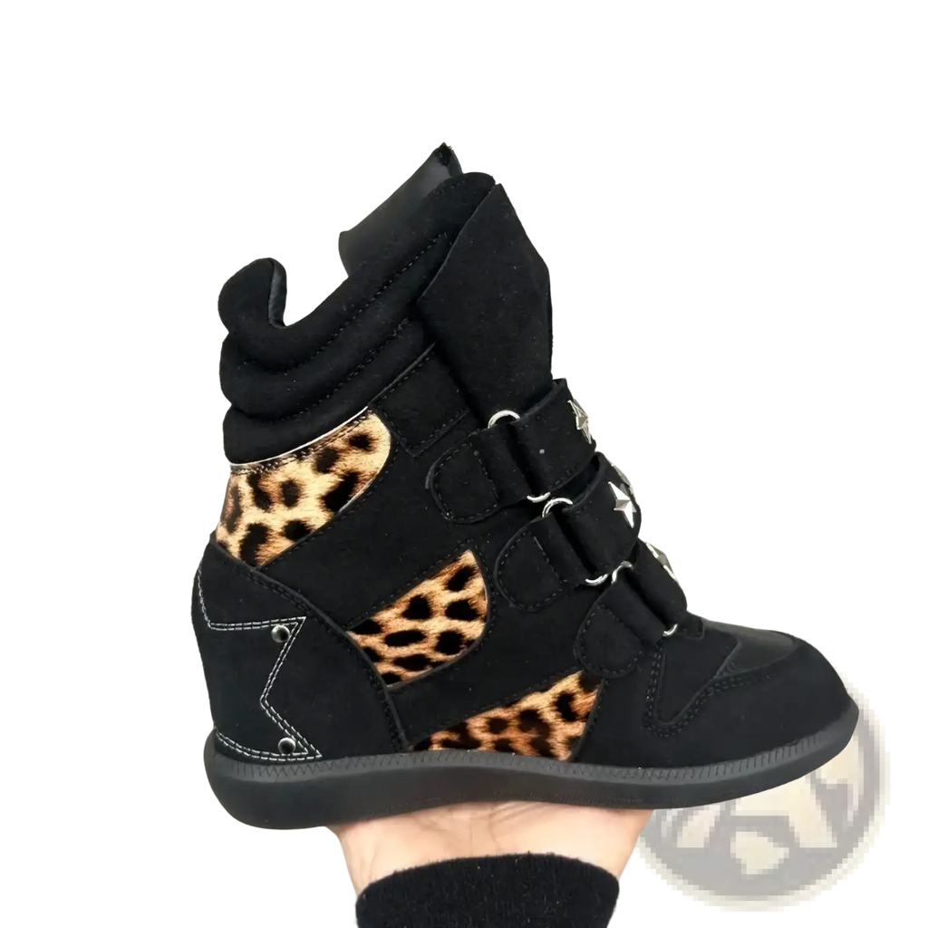 Black suede wedge sneaker with leopard print accents and star shaped metal buckles in leopard print wedge ankle boots
