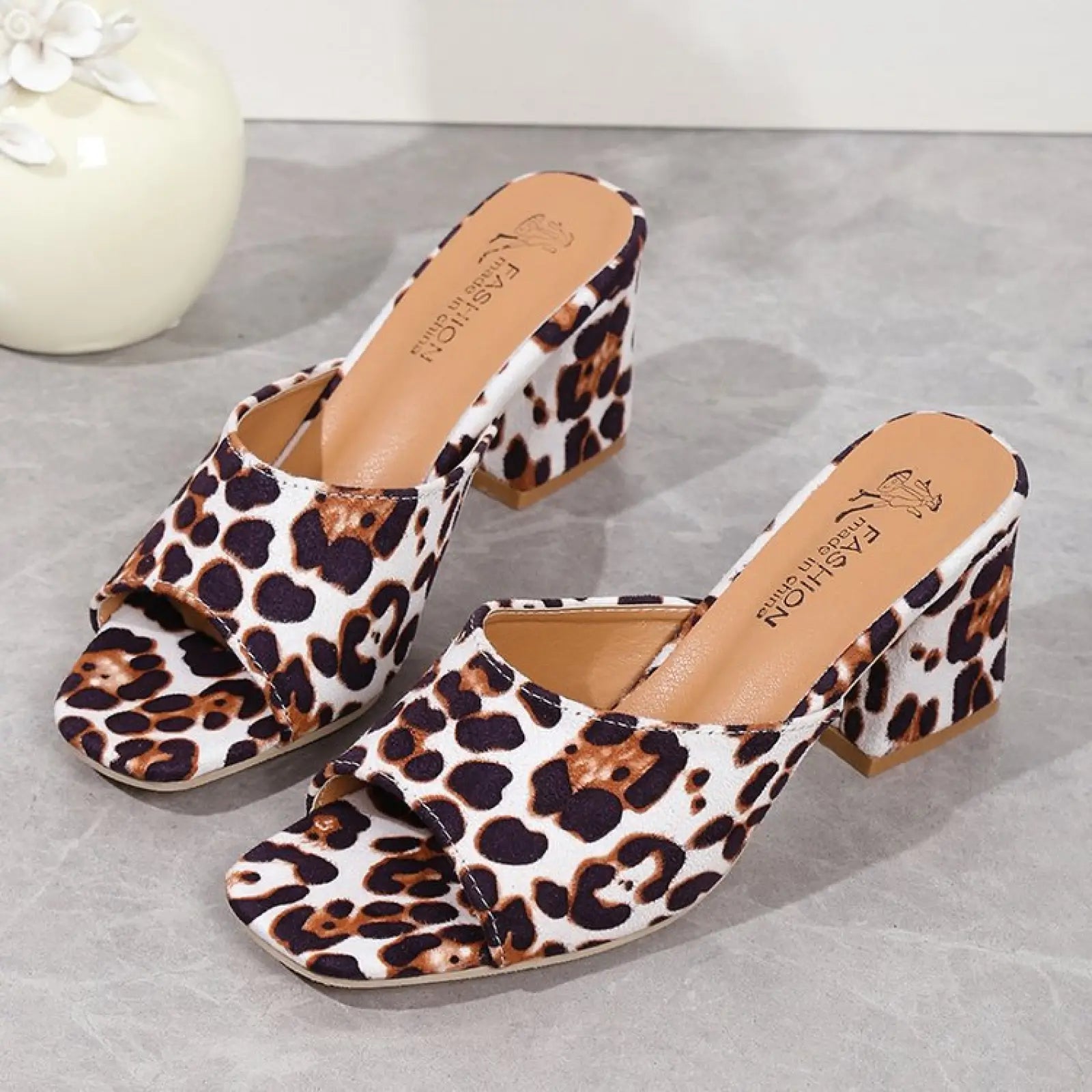Leopard square toe chunky heel sandals featuring leopard print mule design with open toe and a sturdy heel