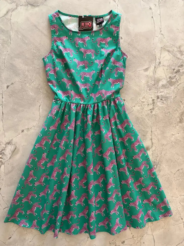 A vibrant green cotton 1950s flare dress with a pink leopard print fitted bodice and sleeveless design