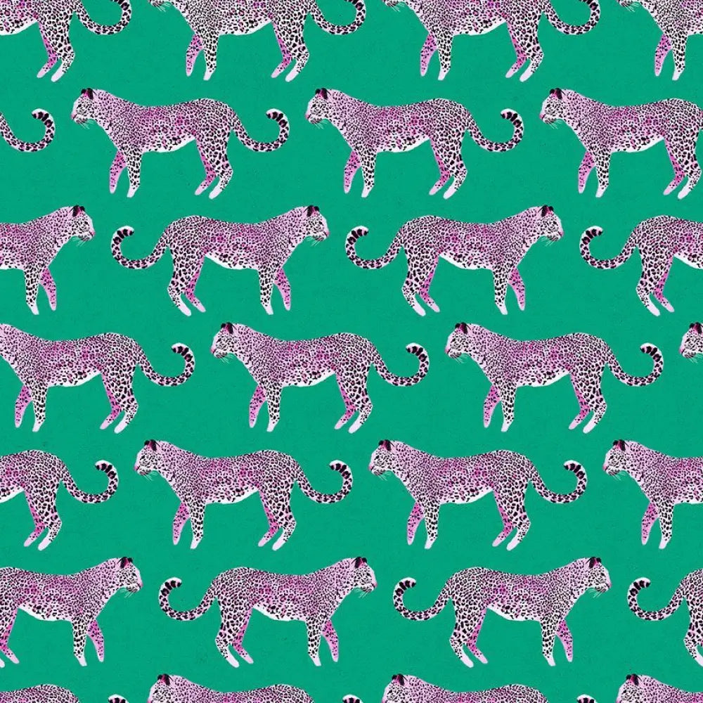 Vintage pink leopard print green cotton fabric with black spots for 1950s flare dress shown on vibrant background