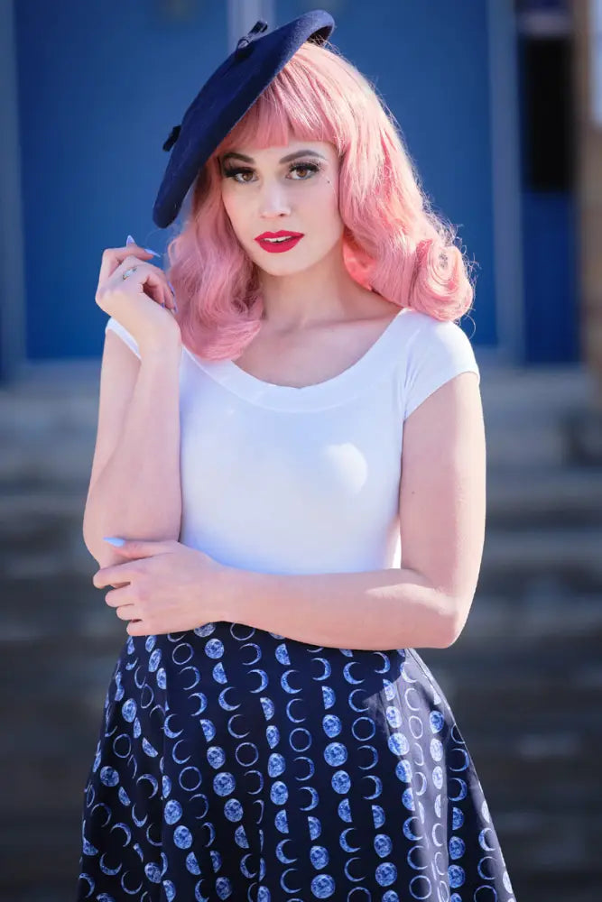 Navy blue beret with black decorative pins paired with a plus size navy celestial moon phase pleated skater skirt