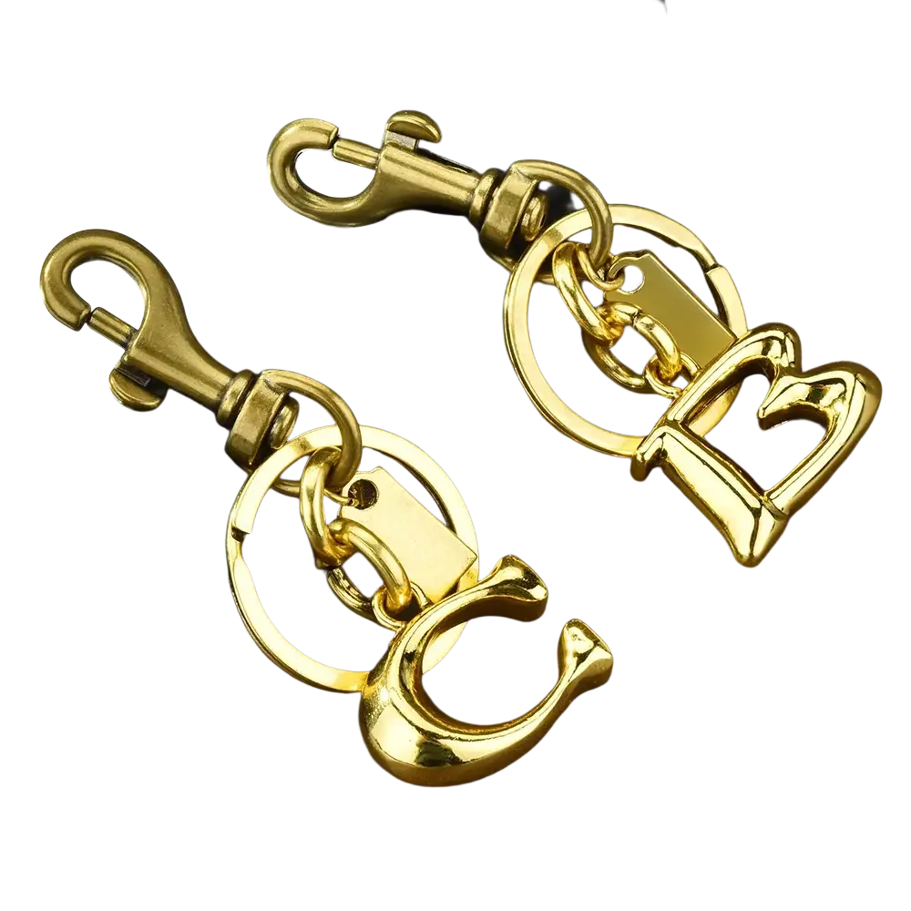 Gold metal keychain with letter b and c initials featuring a sturdy swivel hook for car accessory use