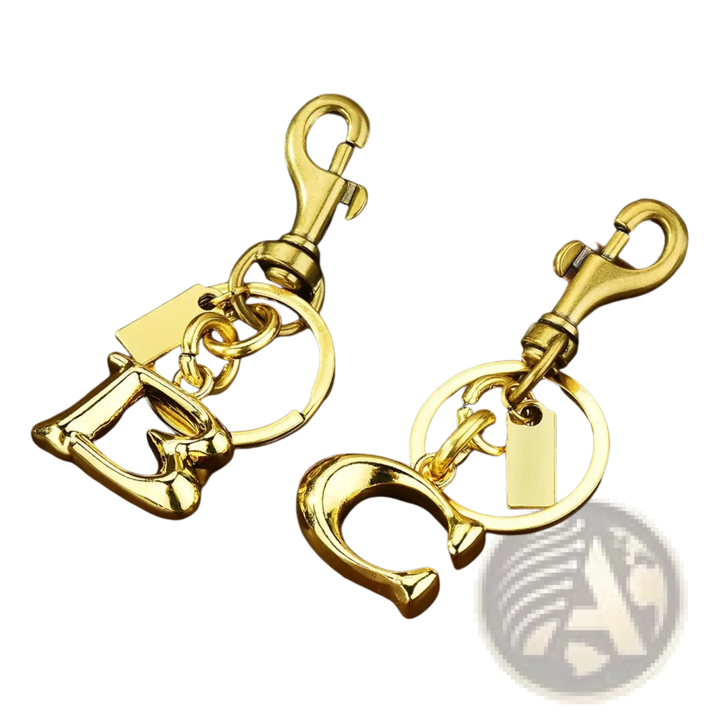 Gold-tone metal letter c and d keychain with polished finish attached to ring and swivel hook for car accessory