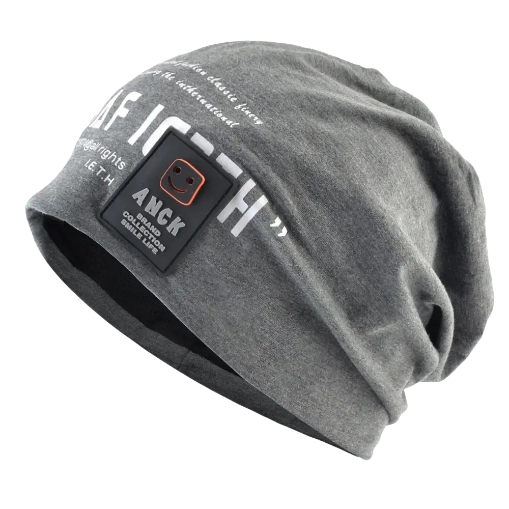 Gray slouchy beanie with white letter print and black anck patch featuring smiling face logo casual streetwear hat