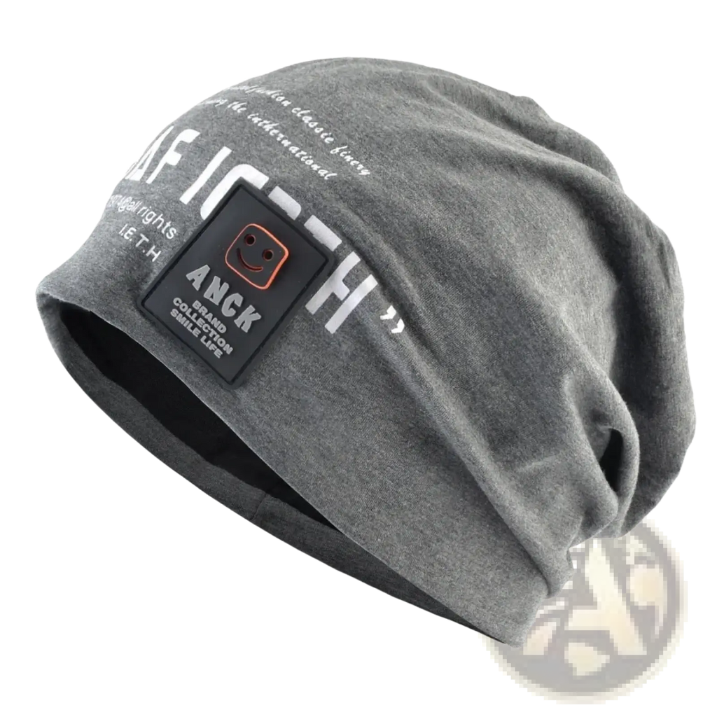 Gray slouchy beanie with white letter print and black anck patch featuring smiling face logo casual streetwear hat