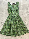 Vintage 1950s sleeveless green cotton dress with cabbage print, fitted bodice, and flared skirt