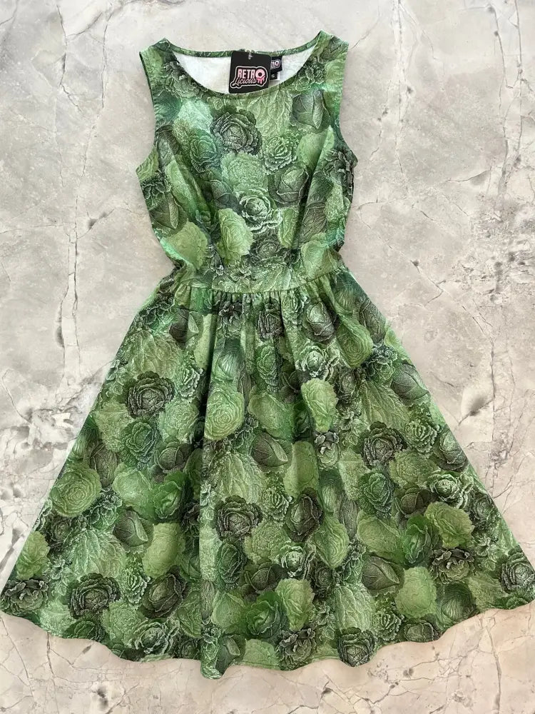 Vintage 1950s sleeveless green cotton dress with cabbage print, fitted bodice, and flared skirt