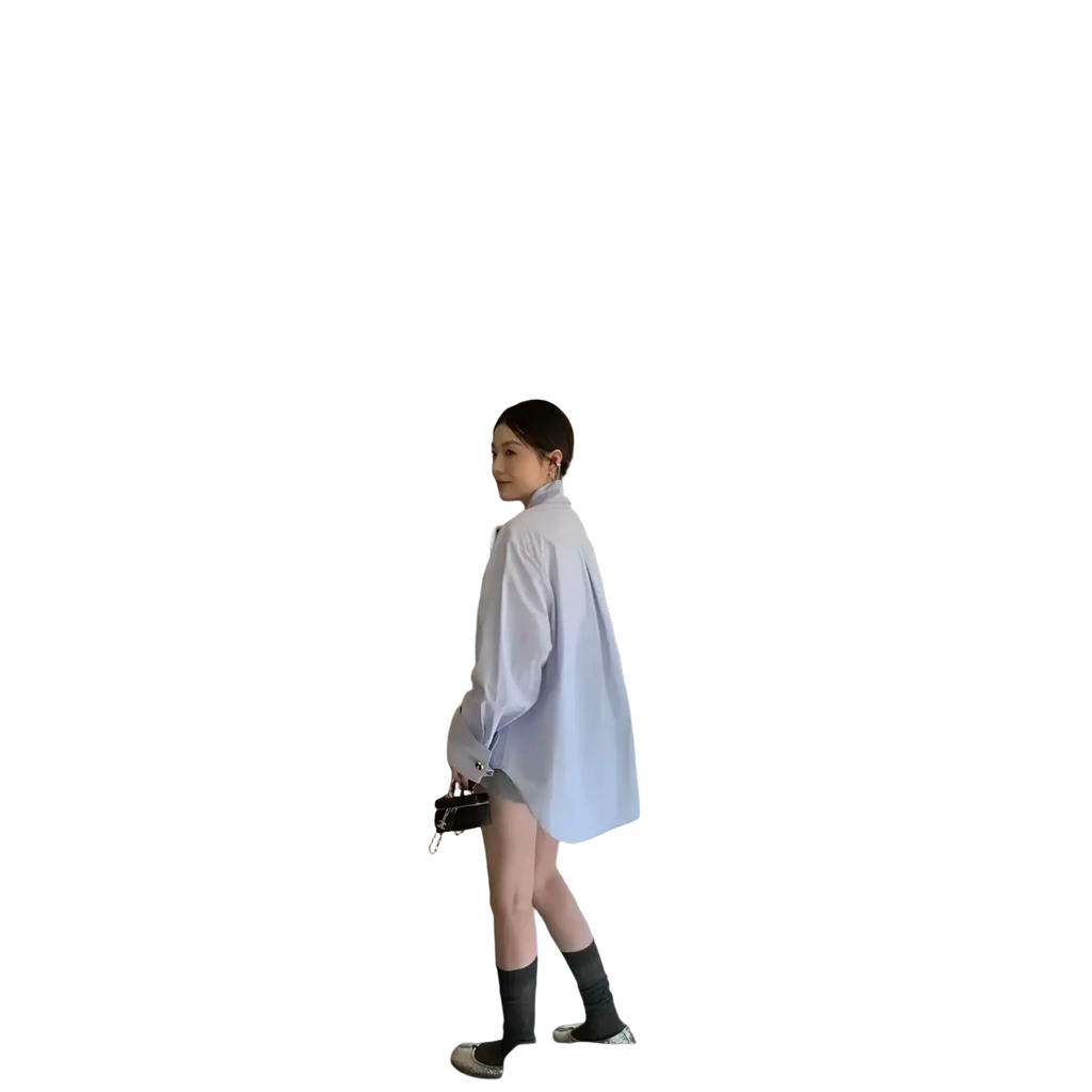 Light blue oversized button up shirt with relaxed fit and subtle collar made from soft breathable fabric