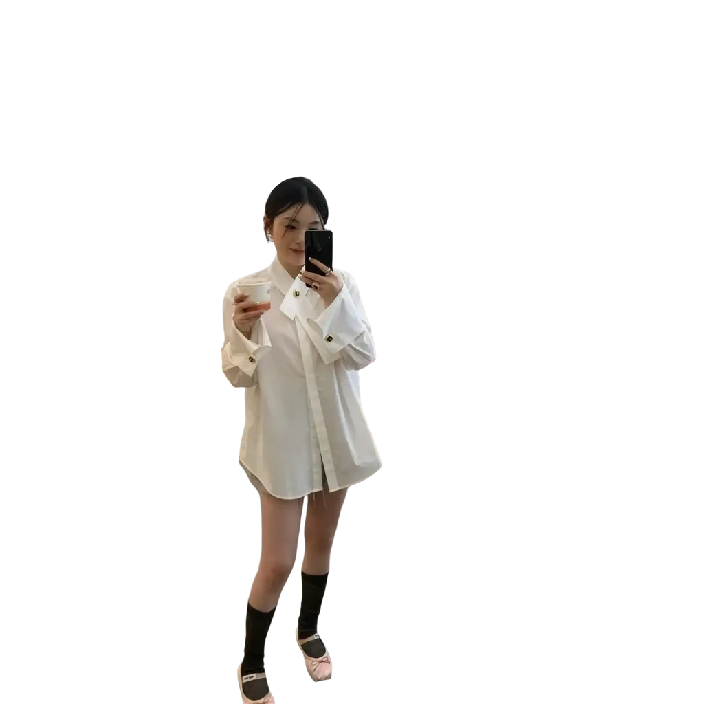 White oversized button-up shirt with long sleeves and relaxed fit shown from the back in light blue color