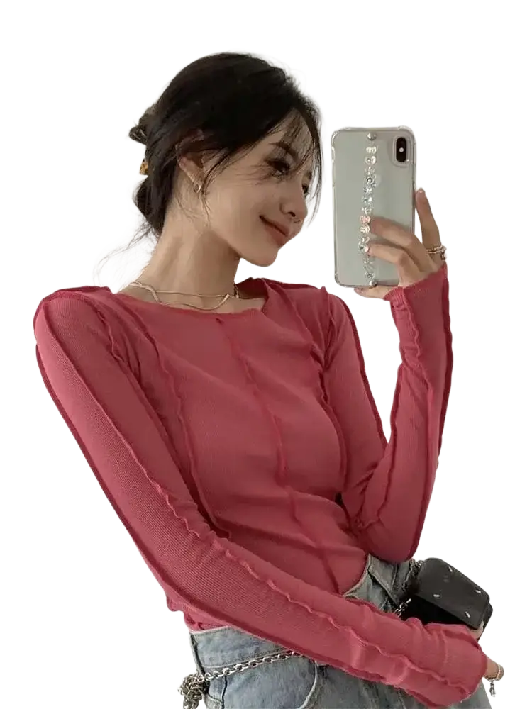A soft pink long-sleeved textured ruched top with a fitted silhouette for casual slim wear