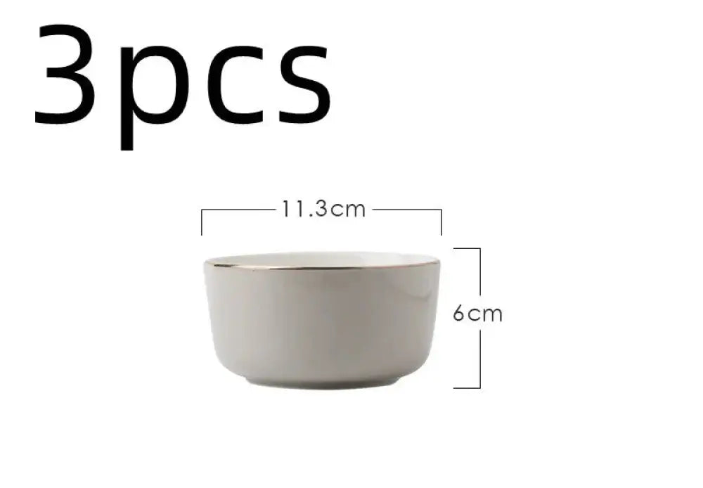 A minimalist white ceramic bowl with metallic rim from luxury pink and gold script ceramic couple dinnerware set
