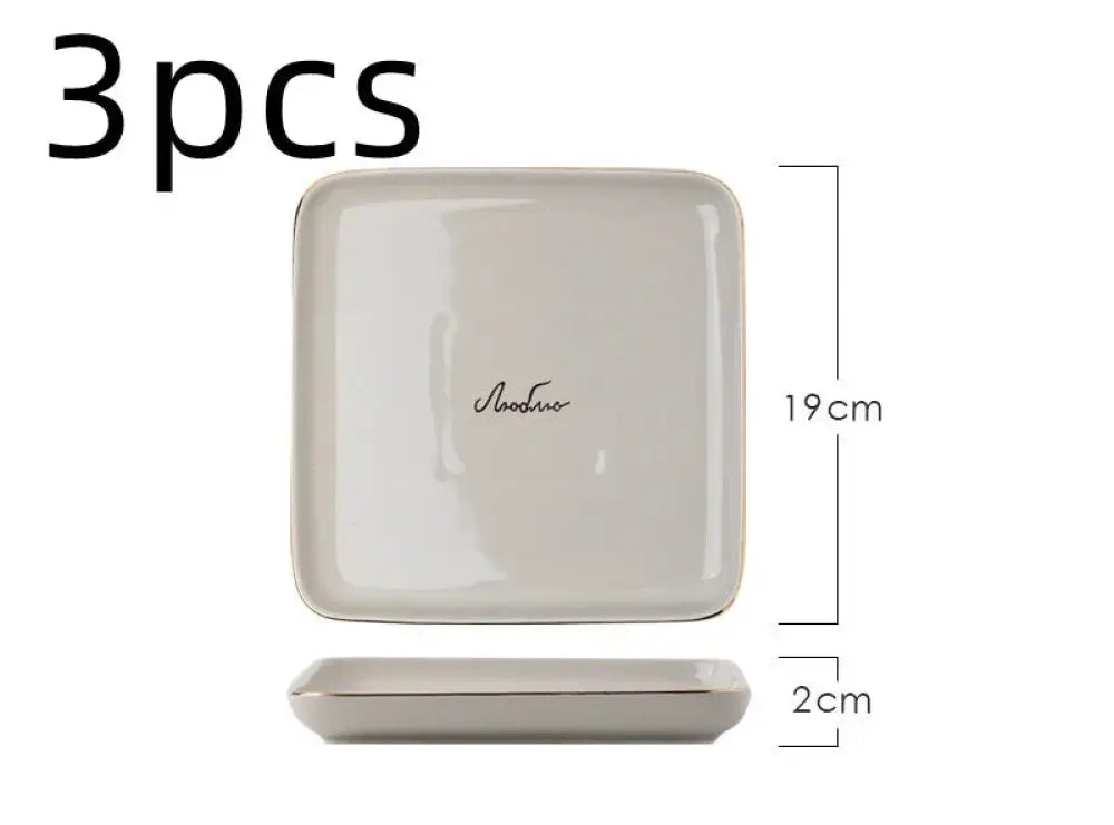Cream-colored square ceramic dish with gold rim and elegant cursive script from luxury pink and gold script couple dinnerware set