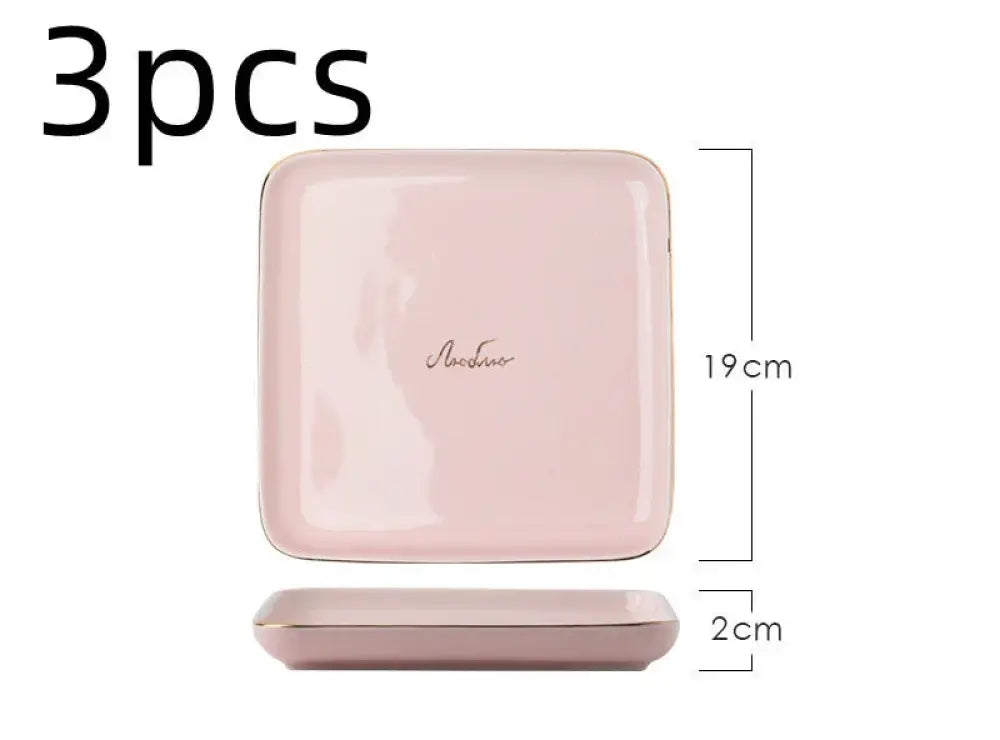 Luxury pink and gold script ceramic couple dinnerware set with a pink square ceramic plate featuring gold trim and cursive logo