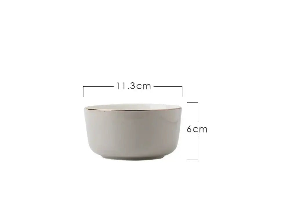 A minimalist white ceramic bowl with a subtle metallic rim from the luxury pink and gold script ceramic couple dinnerware set