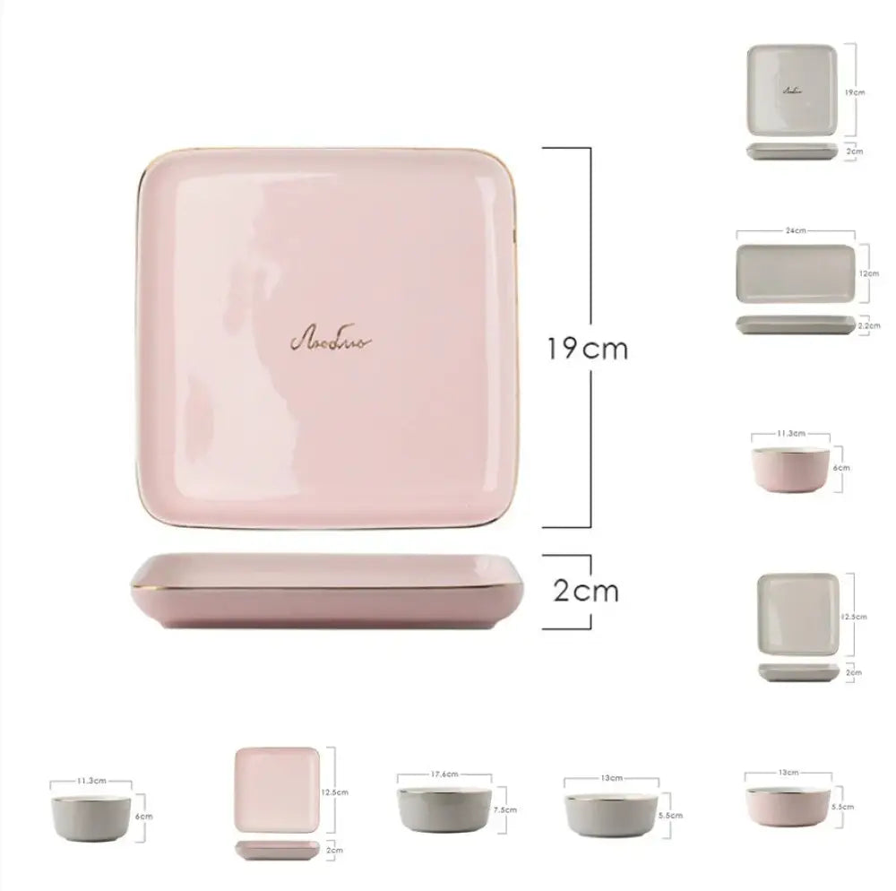 A soft pink ceramic square plate with a subtle gold rim and elegant cursive script from a luxury couple dinnerware set