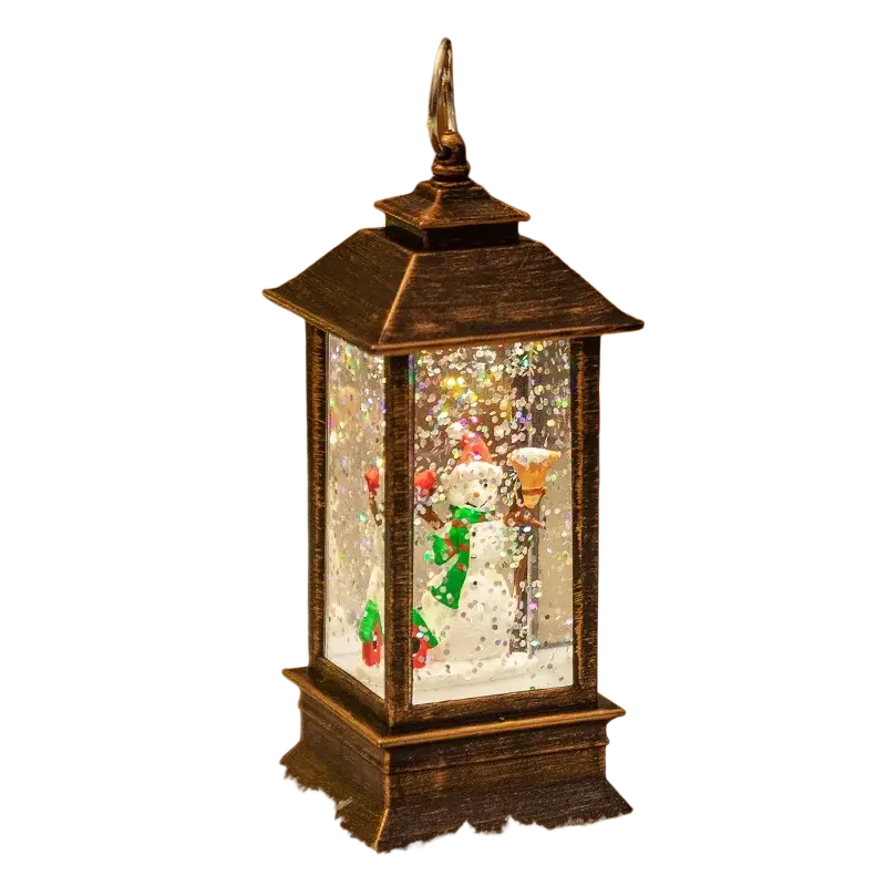 Antique bronze lantern with lighted snowman figurine inside surrounded by glittering faux snow and twinkling lights