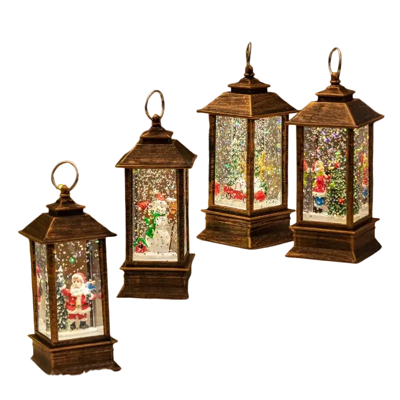 Lighted bronze christmas snow globe lanterns with clear glass panels and miniature illuminated holiday scenes inside