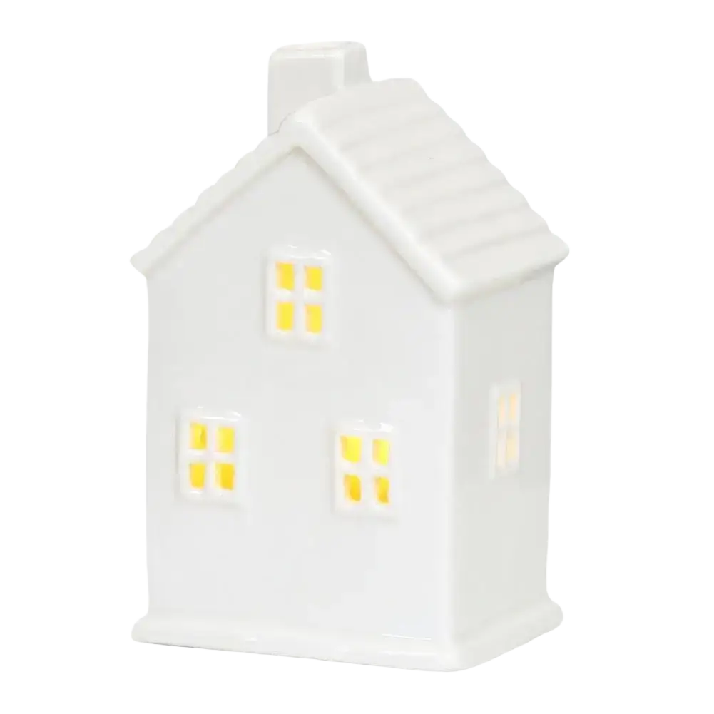 White ceramic christmas village house lamp with glowing yellow led lights creating an enchanting winter wonderland