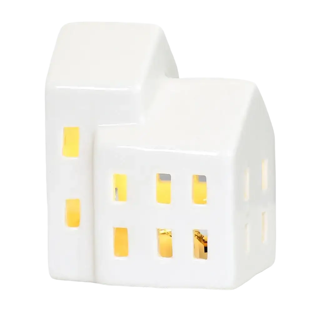 White ceramic house-shaped christmas village lantern with glowing yellow light for enchanting winter wonderland decor