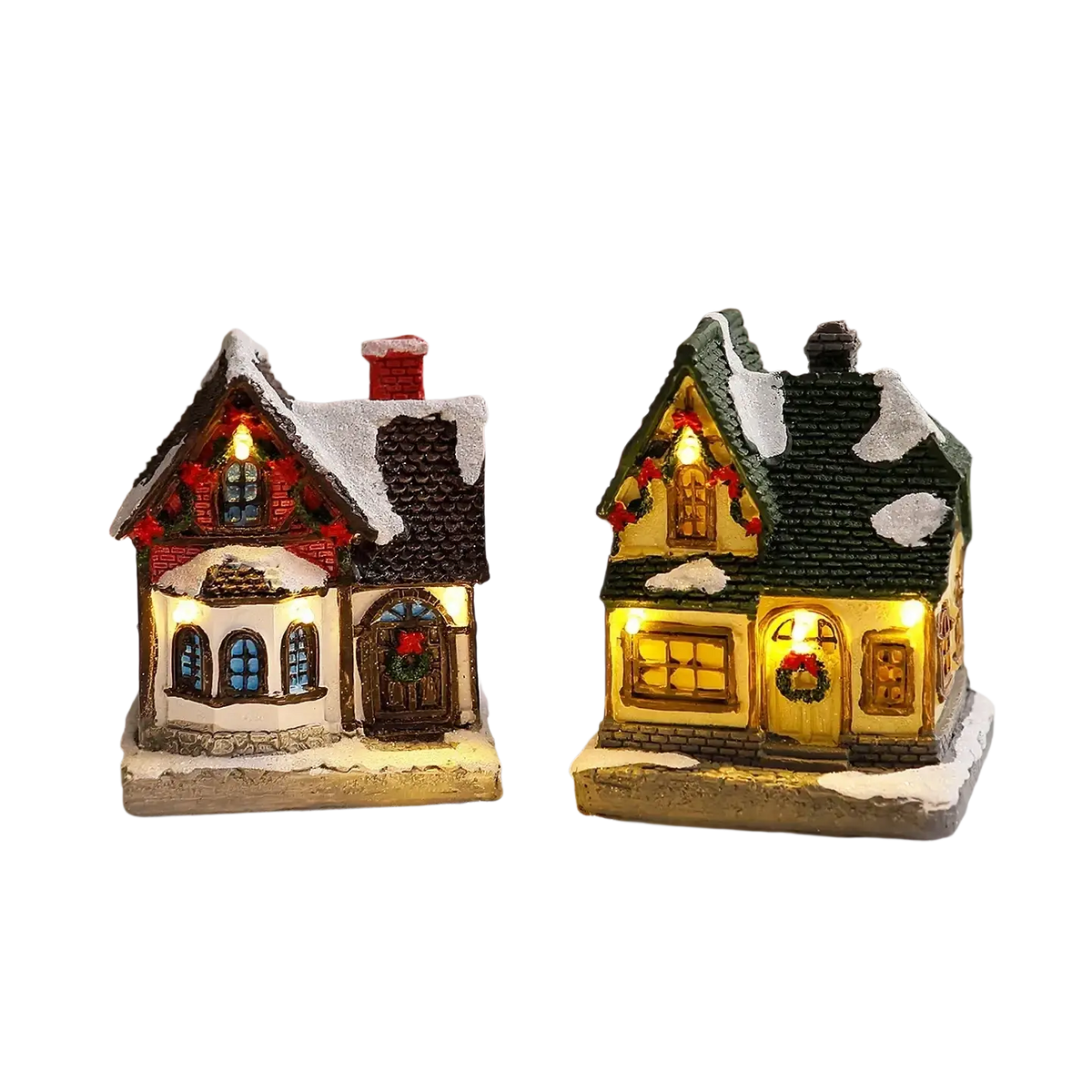 Two miniature lighted christmas village house ornaments with red and green roofs glowing warmly with festive accents