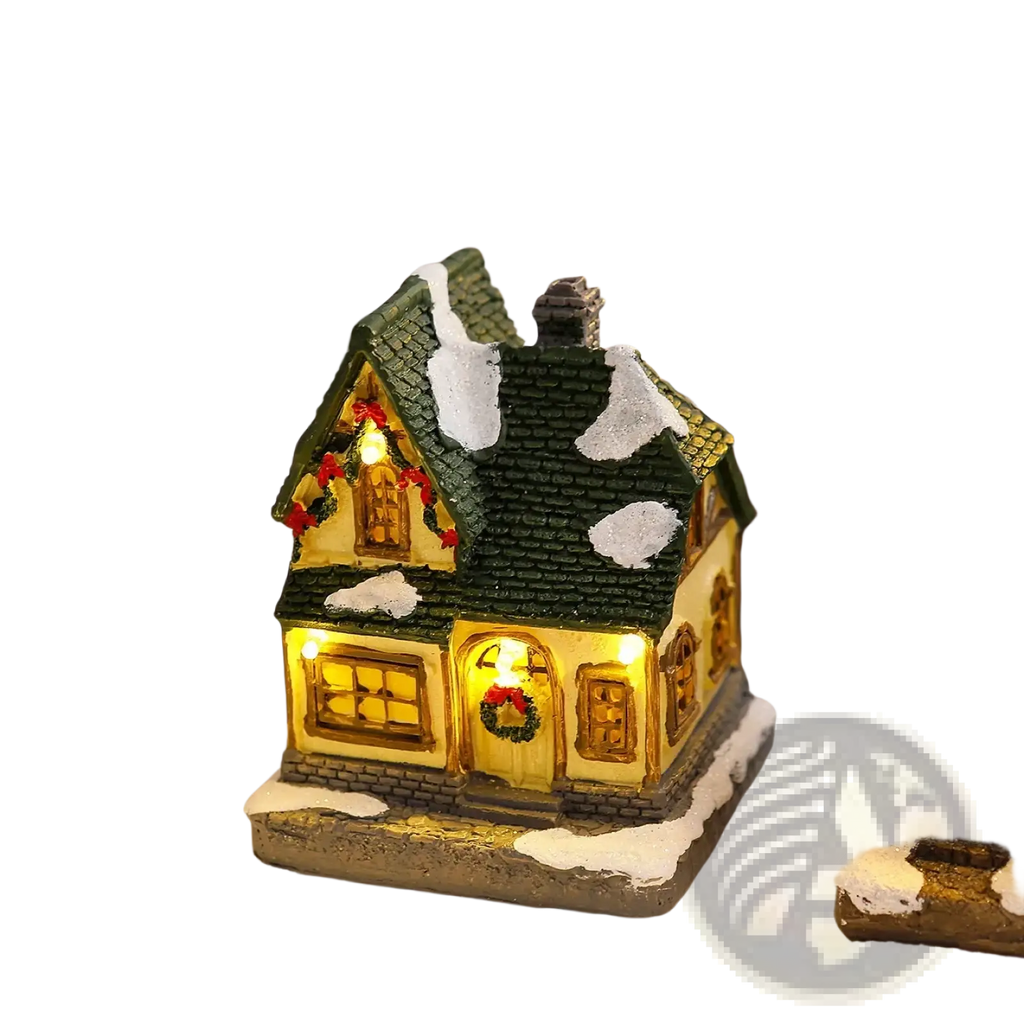 Lighted christmas village house ornament with green shingled roof snow-dusted details and festive wreaths on windows and door