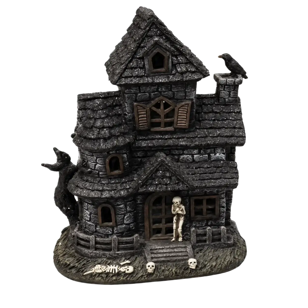 Dark gray textured resin lighted haunted house figurine with crooked roof, skeleton figure, skulls, and crow details