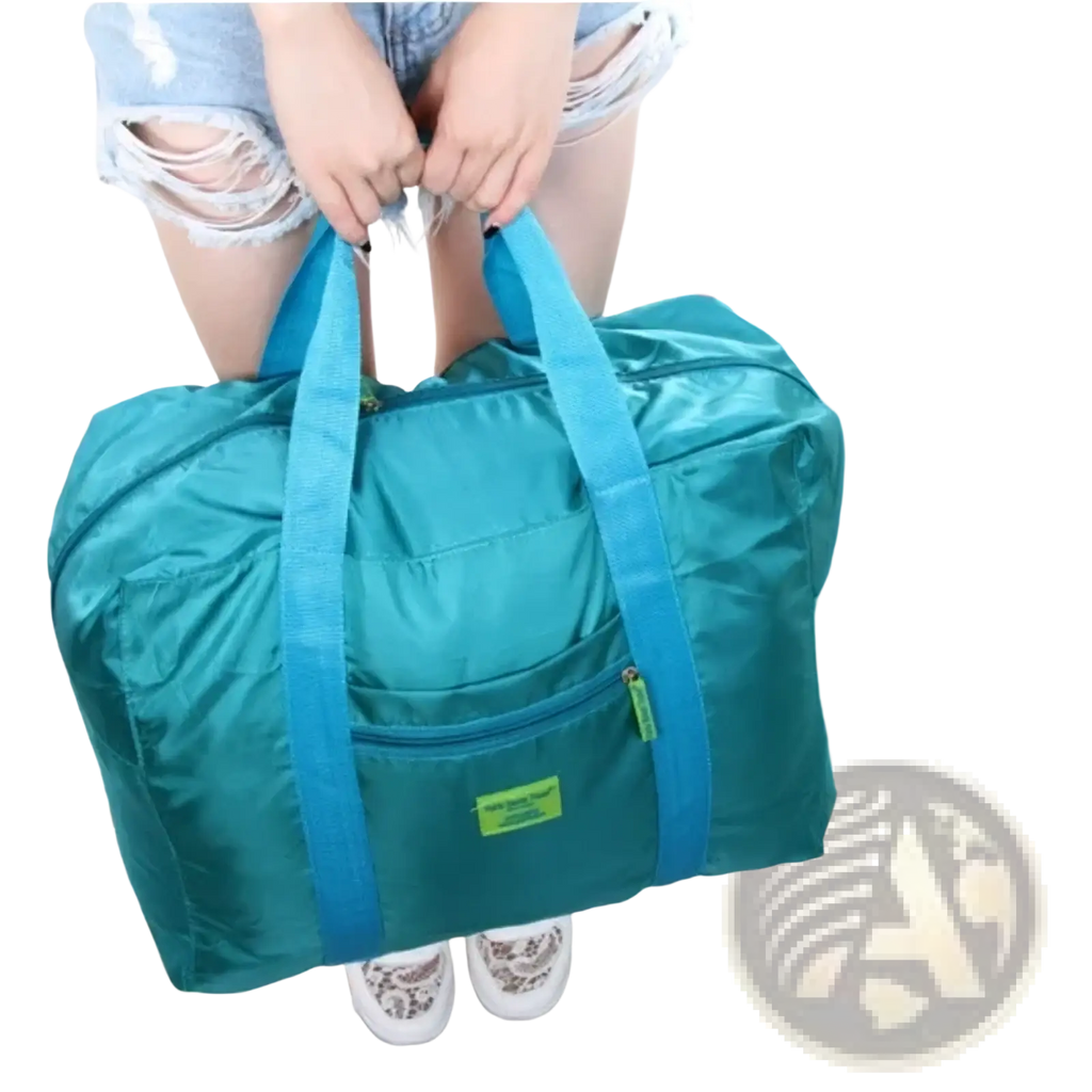 Lightweight foldable travel duffel bag in teal with blue handles and a green label for easy portability